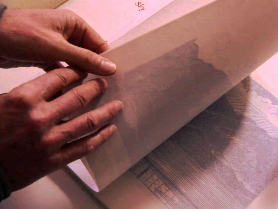 Hands leafing a page on a book